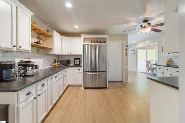 kitchen with ceiling fan, dark countertops, open shelves, light wood finished floors, and stainless steel appliances
