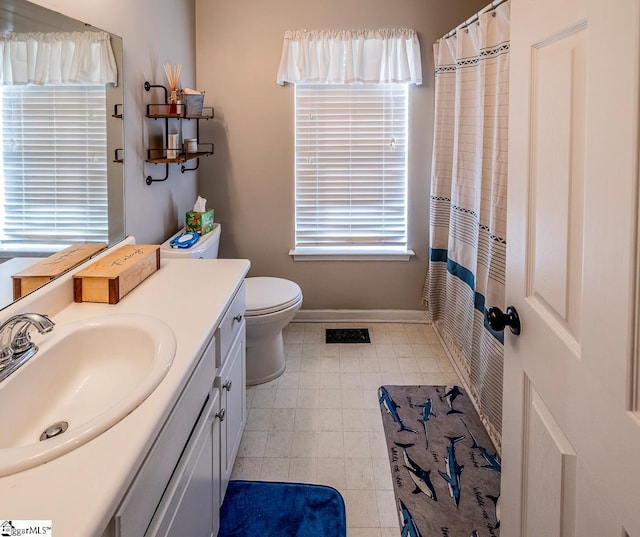 bathroom with vanity, toilet, tile patterned floors, baseboards, and a shower with curtain