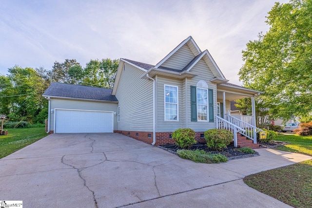 view of front facade with a garage, covered porch, a shingled roof, crawl space, and concrete driveway