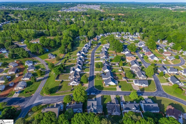 drone / aerial view with a wooded view
