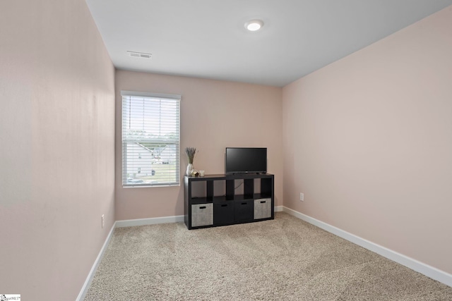 interior space featuring baseboards, carpet flooring, and visible vents