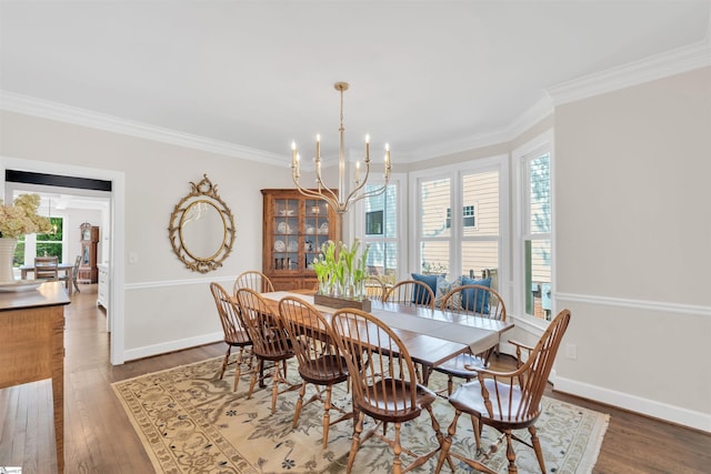 dining room with crown molding, baseboards, a notable chandelier, and wood finished floors