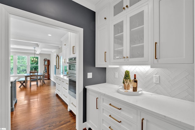 kitchen featuring glass insert cabinets, white cabinets, beam ceiling, and tasteful backsplash