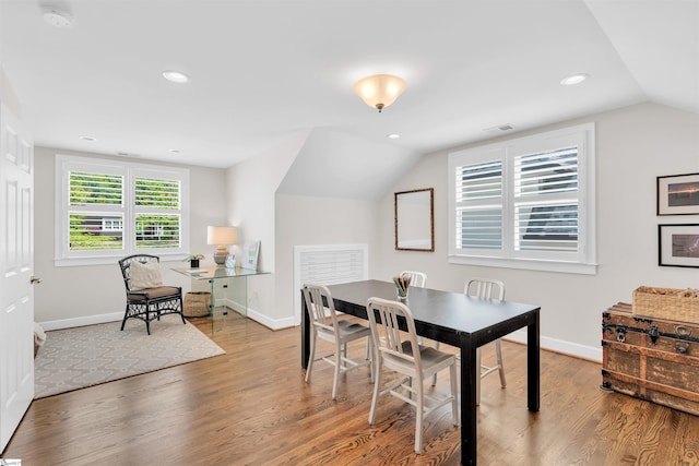 dining room with visible vents, wood finished floors, baseboards, recessed lighting, and vaulted ceiling