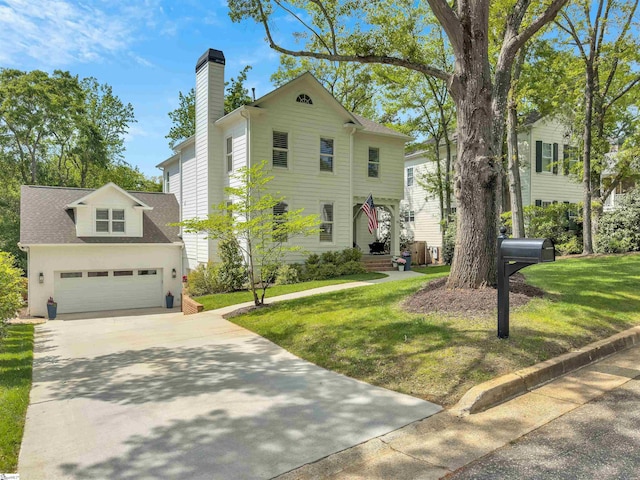 traditional home featuring a garage, a chimney, concrete driveway, and a front yard