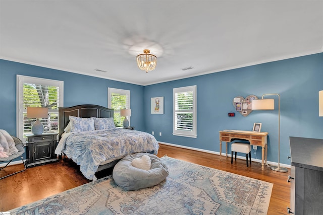 bedroom featuring crown molding, a notable chandelier, multiple windows, and visible vents