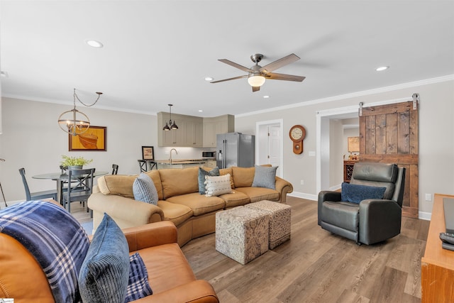 living room featuring baseboards, ceiling fan, and recessed lighting
