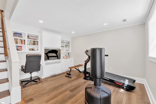 exercise area with recessed lighting, baseboards, visible vents, and light wood-style flooring