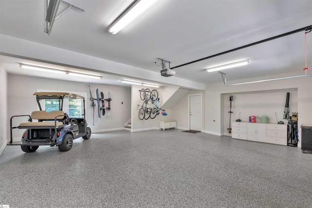 garage featuring baseboards and a garage door opener