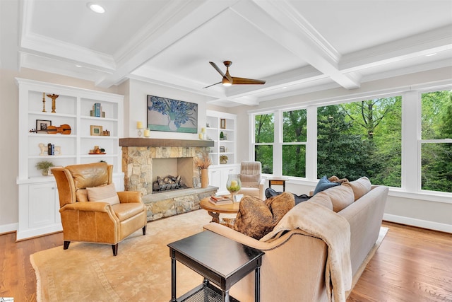 living area with ceiling fan, a fireplace, light wood-style flooring, beamed ceiling, and coffered ceiling