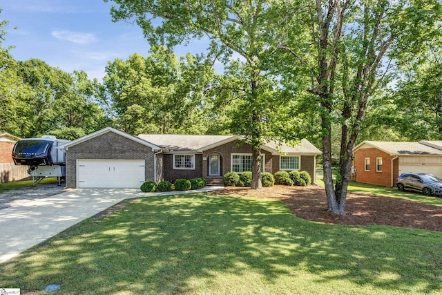 ranch-style home featuring brick siding, a garage, a front lawn, and concrete driveway