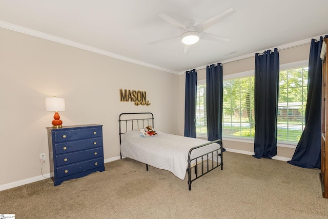 bedroom with crown molding, carpet flooring, ceiling fan, and baseboards