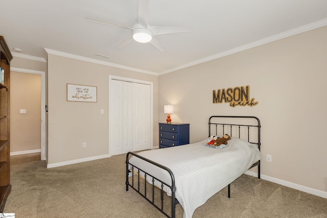 bedroom with a closet, ornamental molding, baseboards, and carpet flooring
