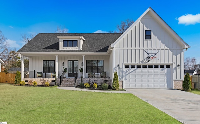 view of front of house featuring a front yard, french doors, a shingled roof, board and batten siding, and a porch