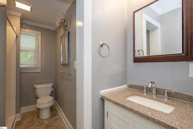 bathroom with vanity, ornamental molding, baseboards, and toilet