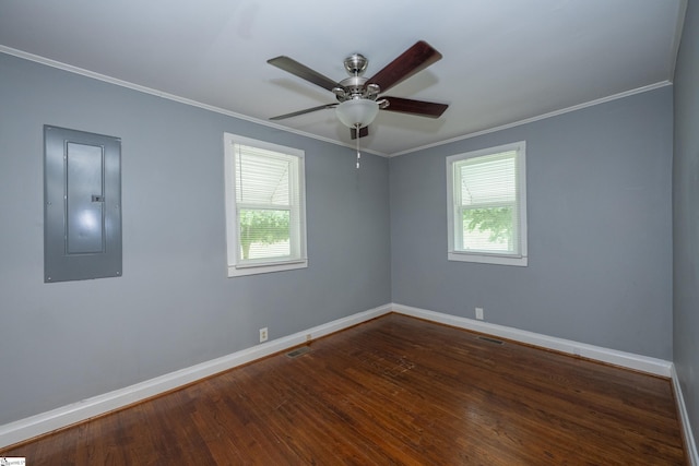 empty room with a healthy amount of sunlight, ornamental molding, and electric panel