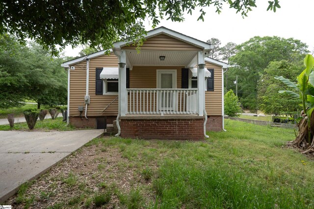 bungalow-style house with a porch and a front yard