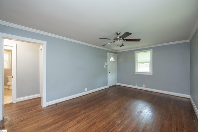 spare room featuring baseboards, ornamental molding, and hardwood / wood-style floors