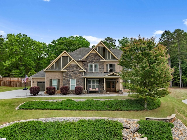 35 Laurelhart Ln, Simpsonville, SC 29681 - craftsman-style home with fence, a front yard, driveway, and stone siding