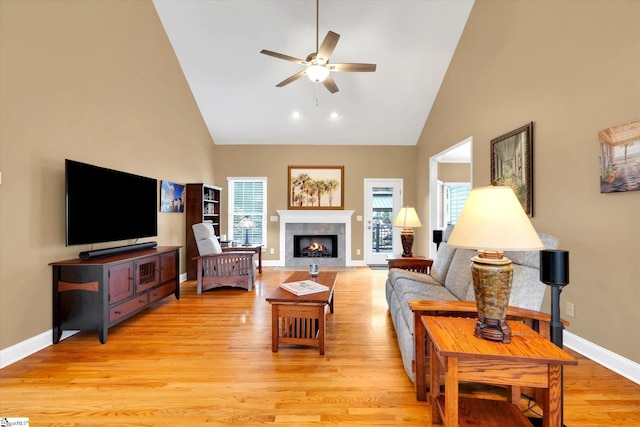 living room with plenty of natural light, high vaulted ceiling, and ceiling fan