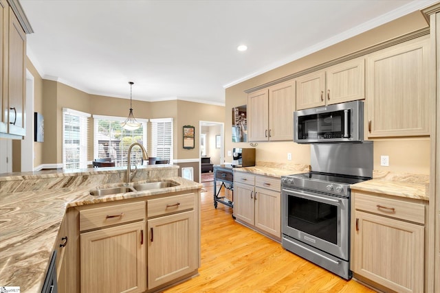 kitchen featuring a sink, light wood-style flooring, light brown cabinetry, and stainless steel appliances