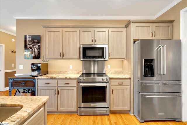 kitchen with crown molding, appliances with stainless steel finishes, and light brown cabinetry