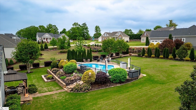 view of pool with a gazebo, a residential view, a yard, and a fenced in pool
