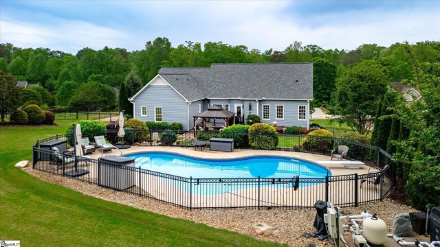view of swimming pool featuring fence, a gazebo, a fenced in pool, a patio area, and a lawn