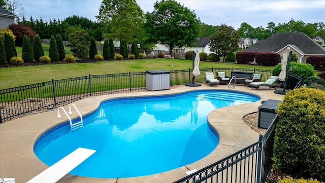 view of swimming pool with a diving board, fence, a fenced in pool, an outdoor hangout area, and a yard