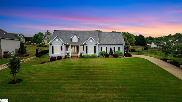 view of front of property with fence, driveway, and a front yard