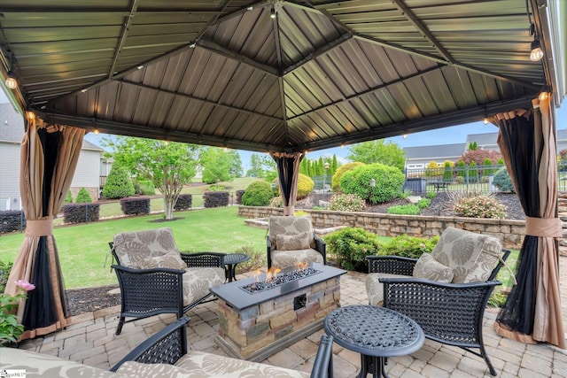 view of patio featuring a gazebo, fence, and a fire pit