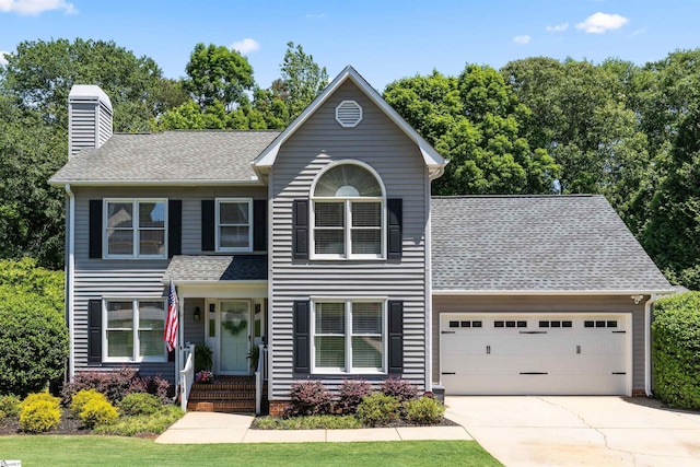 view of front of property with an attached garage, a shingled roof, a chimney, and concrete driveway