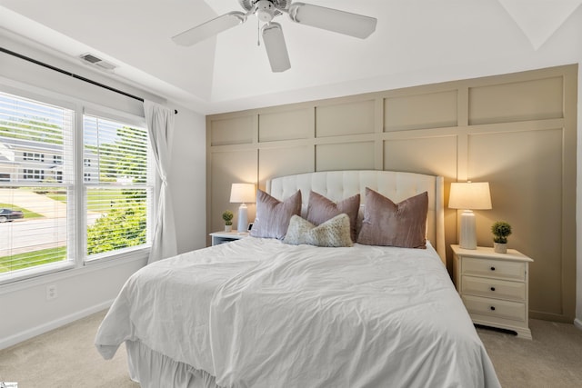 bedroom with baseboards, light colored carpet, multiple windows, and visible vents