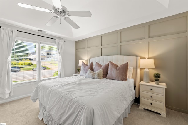 bedroom featuring light colored carpet, baseboards, visible vents, and ceiling fan