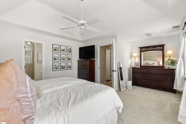 bedroom featuring baseboards, ceiling fan, light colored carpet, and visible vents