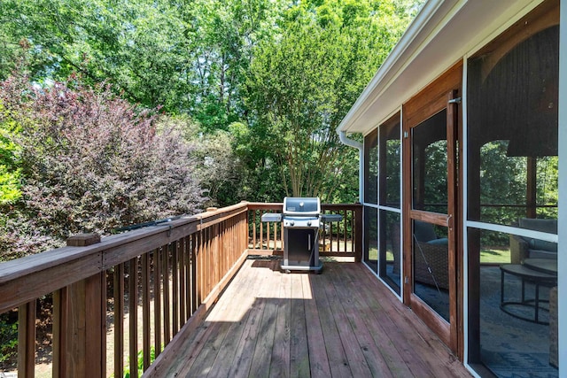 deck with a sunroom and a grill