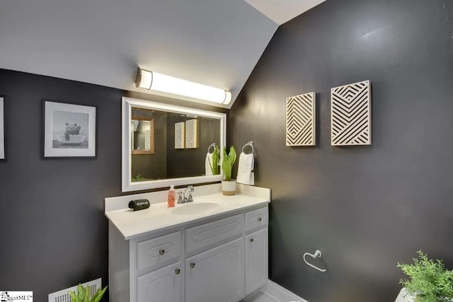 bathroom featuring vanity and vaulted ceiling