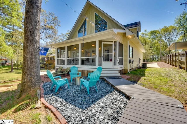 back of house with fence, central AC unit, a sunroom, and crawl space