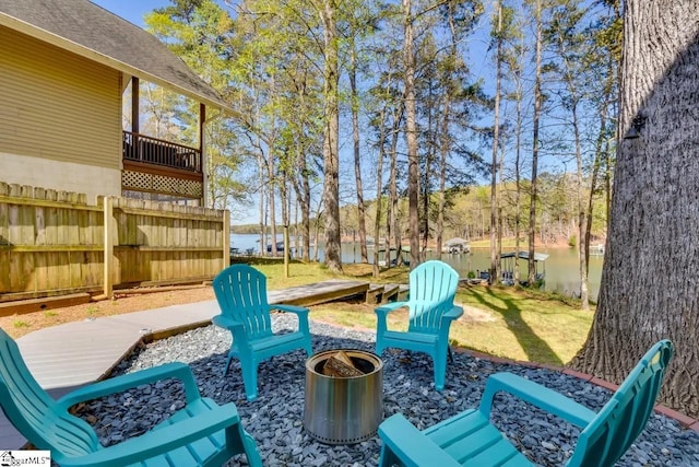 view of patio / terrace with a fire pit and fence