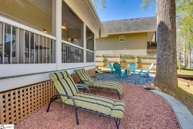 view of patio with a sunroom and fence
