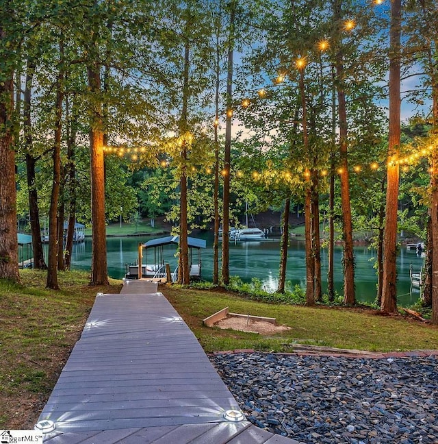 view of property's community featuring a water view and a dock