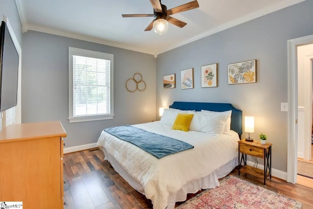 bedroom featuring crown molding, baseboards, a ceiling fan, and wood finished floors