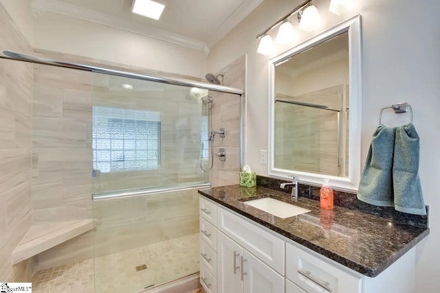 full bath with vanity, ornamental molding, and a stall shower