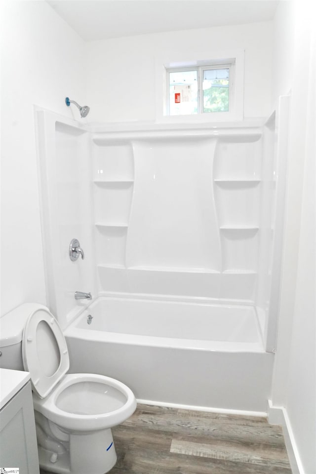 full bathroom with vanity, toilet, wood finished floors, and  shower combination