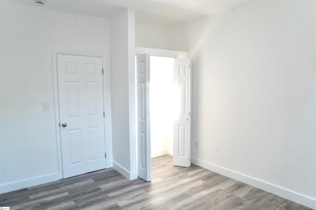 unfurnished bedroom featuring baseboards and wood finished floors