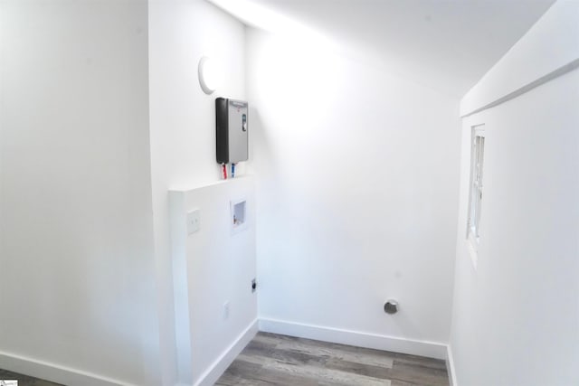 laundry area with baseboards, laundry area, washer hookup, and wood finished floors