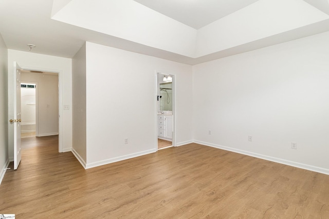 empty room featuring light wood-style floors and baseboards