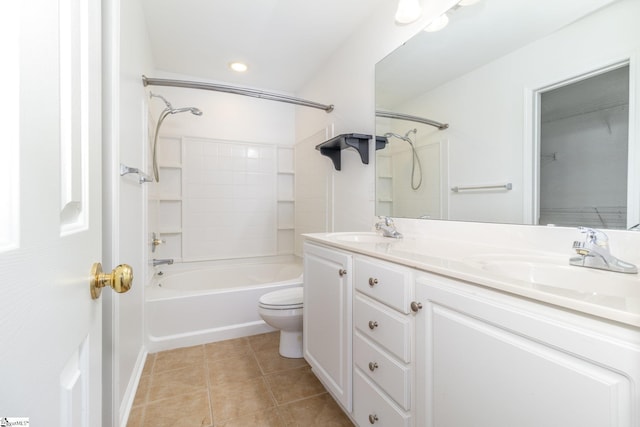 bathroom with double vanity, toilet, a sink, and tile patterned flooring