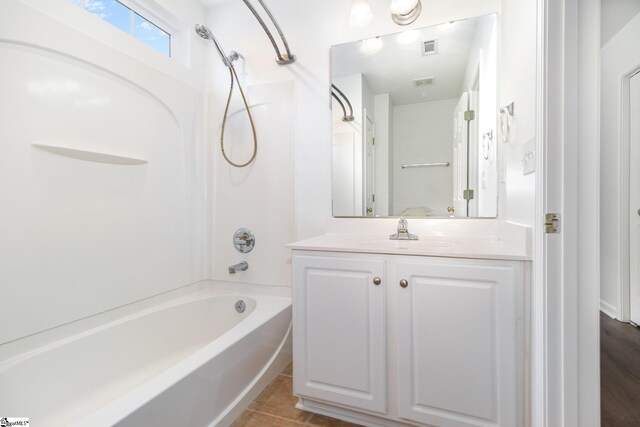 bathroom with vanity, visible vents, tile patterned floors, and tub / shower combination