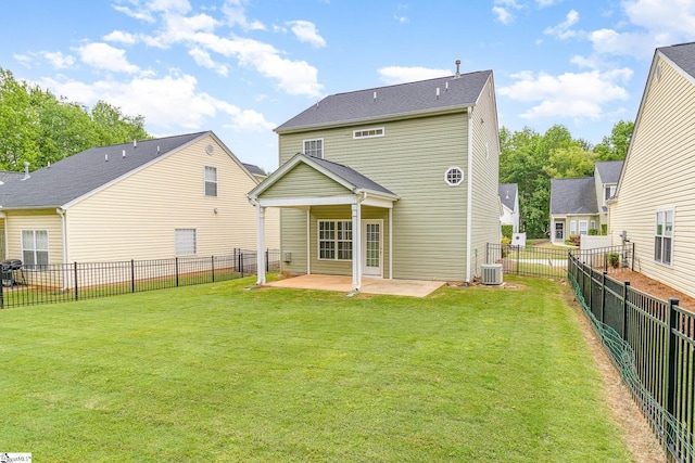 back of house with a fenced backyard, a patio, and a yard